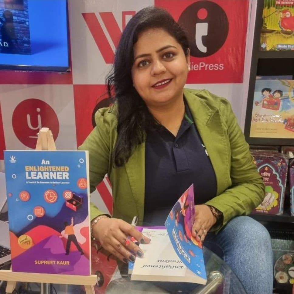 Supreet Kaur, founder of Hidden Potential, at a book signing event with her book An Enlightened Learner